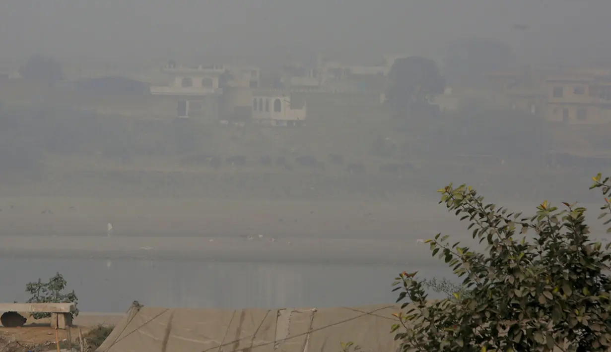 Kabut asap tebal menyelimuti Sungai Ravi dan daerah sekitarnya di Lahore, Pakistan, Rabu (11/11/2020). Kabut asap yang menyelimuti Lahore mendorong para dokter untuk mendesak orang-orang agar tetap di rumah. (AP Photo/K.M. Chaudary)