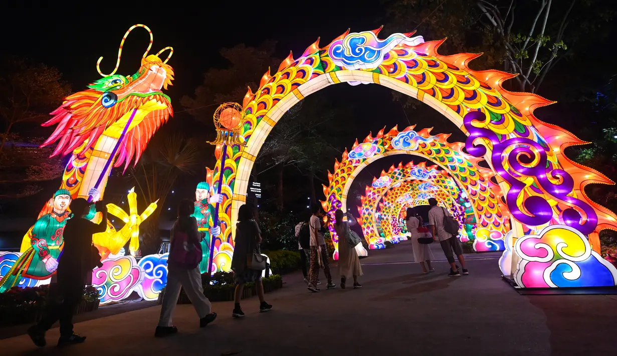 Pengunjung melihat lentera naga selama pratinjau media untuk Mid-Autumn Festival di Gardens by the Bay, Singapura, Selasa (27/8/2019). Festival ini sebagai penanda berakhirnya panen musim gugur, atau Mid-Autumn sekaligus merupakan momen untuk memanjatkan syukur kepada dewa-dewi. (Roslan RAHMAN/AFP)