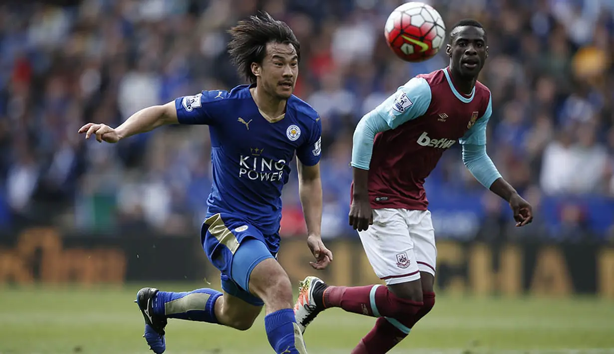 Gelandang Leicester, Shinji Okazaki, berebut bola dengan gelandang West Ham, Cheikhou Kouyate, pada laga Liga Premier Inggris di Stadion King Power, Leicester, Minggu (17/4/2016). Pada laga ini The Foxes sempat unggul 1-0. (AFP/Adrian Dennis)