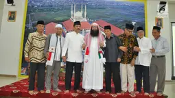 Sheikh Dr Muraweh Musa Nasar (tengah) foto bersama pengurus MAJT Semarang diapit oleh KH Noor Ahmad dan Ali Mufiz, saat berkunjung ke MAJT, Kota Semarang, (Senin 22/4). (Liputan6.com/Gholib)