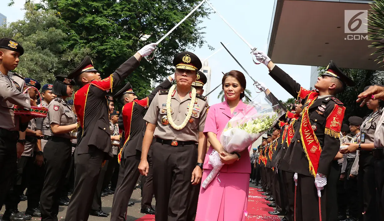 Mantan Kapolda Metro Jaya Irjen M. Iriawan didampingi istri diantar Kapolda Metro Jaya Irjen Idham Azis saat meninggalkan Polda Metro Jaya dalam acara pisah sambut, Jakarta, Rabu (26/7). (Liputan6.com/Immanuel Antonius)