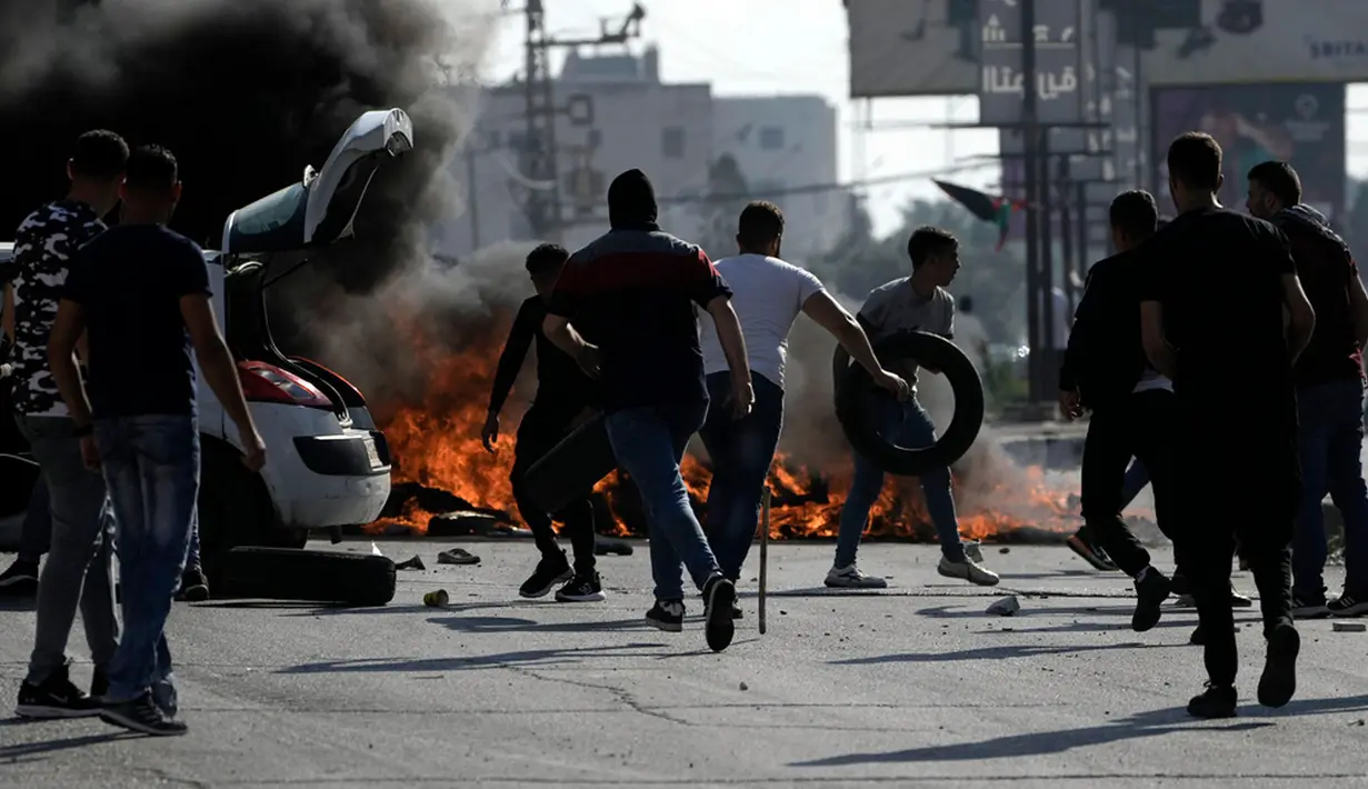 Para pedemo juga membakar ban sebagai bentuk protes mereka. Aksi ini sebagai protes besar-besaran mengecam serangan Israel ke Jalur Gaza. (AP Photo/Nasser Nasser)