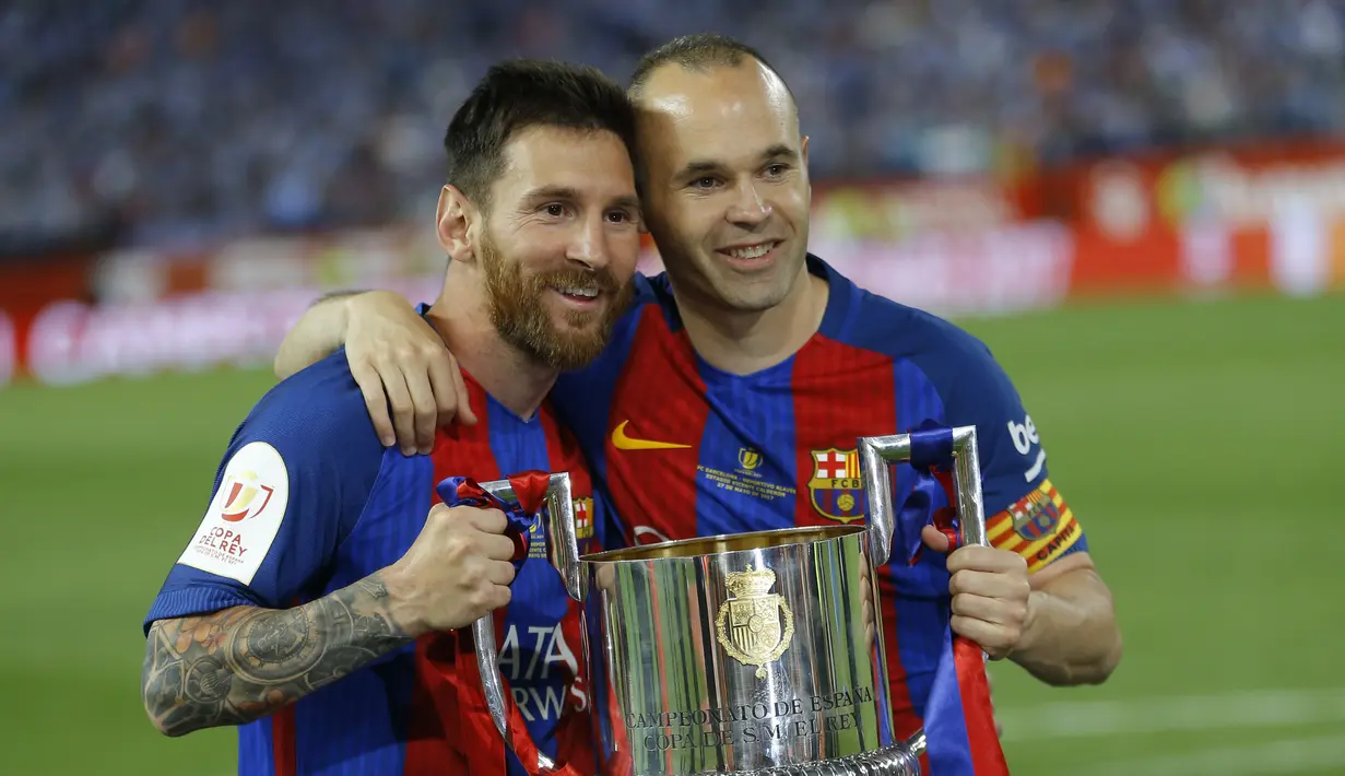 Pemain Barcelona Lionel Messi dan Andres Iniesta mengangkat trofi Piala Raja Spanyol (Copa del Rey) di stadion Vicente Calderon, Spanyol, Minggu (28/5). Barca mengalahkan Alaves 3-1 di laga final tersebut. (AP Photo)