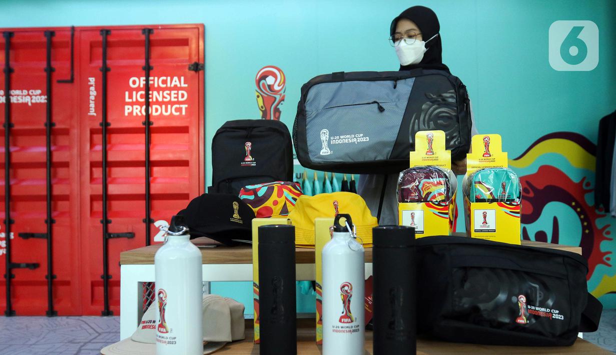 Petugas merapikan merchandise Piala Dunia U-20 2023 di Jakarta, Kamis (30/3/2023). PT. Juara Raga Adidaya (Juaraga) selaku pemegang lisensi merchandise untuk Piala Dunia U-20 2023 merasakan dampak besar dari pencoretan Indonesia sebagai tuan rumah, dikarenakan Juaraga telah memproduksi 53 jenis merchandise. (Liputan6.com/Herman Zakharia)