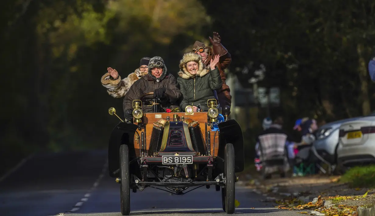 Peserta London to Brighton Veteran Car Run melewati desa Staplefield, London tenggara, Minggu (7/11/2021). Untuk memenuhi syarat, mobil yang berpartisipasi harus dibuat sebelum tahun 1905. (Kirsty O'Connor/PA via AP)