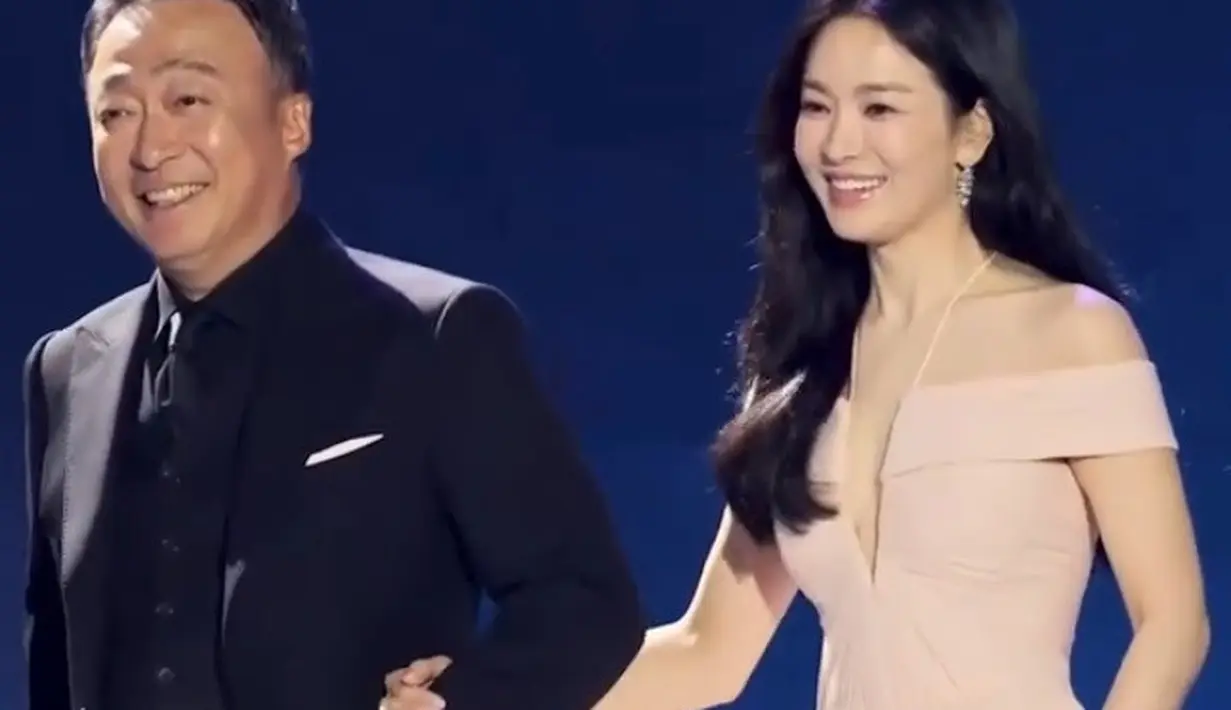 Song Hye Kyo mengenakan sebuah gaun dengan detail halter-strap-neck berwarna apricot. Penampilannya semakin sempurna dengan detail perhiasan mewah dari Chaumet Paris. [Foto: Instagram/choijaehoon.official]