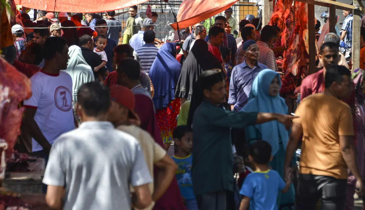Warga Aceh memadati pasar tradisional untuk membeli daging sapi pada perayaan tradisi Meugang Ramadan 1440 Hijriah di Banda Aceh, 4 Mei 2019. Meugang merupakan tradisi turun temurun masyarakat Aceh dengan membeli, mengolah, hingga menyantap daging bersama keluarga. (CHAIDEER MAHYUDDIN/AFP)