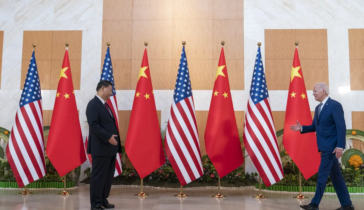 Presiden AS Joe Biden berjalan untuk menyambut Presiden China Xi Jinping sebelum pertemuan di sela-sela KTT G20 di Nusa Dua, di Bali, Senin (14/11/2022). Pertemuan kedua Presiden tersebut akhirnya terwujud di Bali. Suasana pertemuan bersejarah itu tampak hangat. (AP/Alex Brandon)