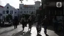 Warga berjalan-jalan di kawasan wisata Kota Tua Jakarta, Rabu (9/12/2020). Libur pelaksanaan Pilkada Serentak 2020 dimanfaatkan sejumlah warga untuk berwisata di kawasan Kota Tua Jakarta. (Liputan6.com/Helmi Fithriansyah)