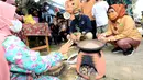 Menteri Parekraf Sandiaga Uno dan Bupati Serang Ratu Tatu Chasanah berbincang dengan emak-emak pelaku UMKM emping pada kunjungannya ke Desa Wisata Cikolelet, Kecamatan Cinangka, Kabupaten Serang, Banten, Sabtu (02/10/2021). (Liputan6.com/HO/Parekraf)