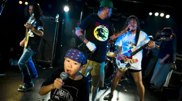 Amon yang berusia 5 tahun dan ayahnya, Shizeru (kanan) tampil sebagai vokalis band punk Saigan Terror di Earthdom, Tokyo, 23 Agustus 2015. (REUTERS/Thomas Peter)