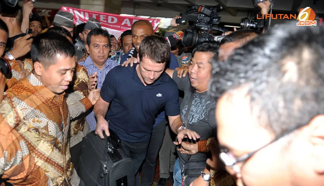 Michael Owen mencoba keluar dari kerumunan fans security maupun media massa (Liputan6.com/Helmi Fithriansyah)