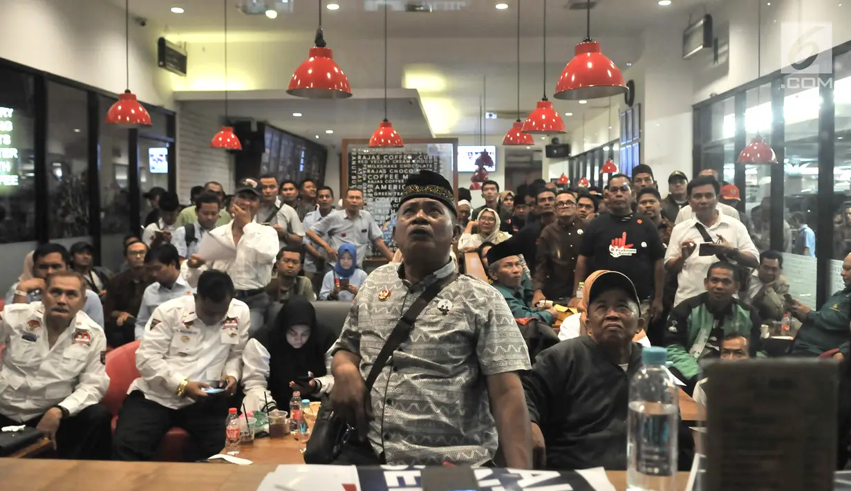 Pendukung Capres dan Cawapres nomor urut 01 dan 02 saat nonton bareng Debat Perdana Pilpres di kafe kawasan Gedung Bidakara, Jakarta, Kamis (17/1). Meskipun tidak diperbolehkan masuk pendukung kedua pasangan tetap antusias. (merdeka.com/Iqbal S Nugroho)