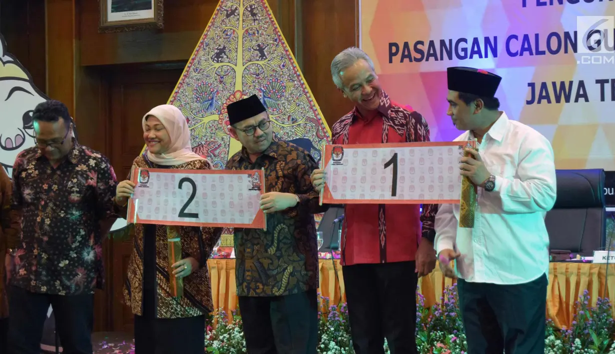 Pasangan calon gubernur Ganjar Pranowo dan Taj Yasin serta Pasangan calon gubernur  Sudirman Said dan Ida Fauziah menunjukkan nomor urut undian calon Gubernur dan Wakil Gubernur Jawa Tengah , Selasa (13/2) malam. (Liputan6.com/Gholib)