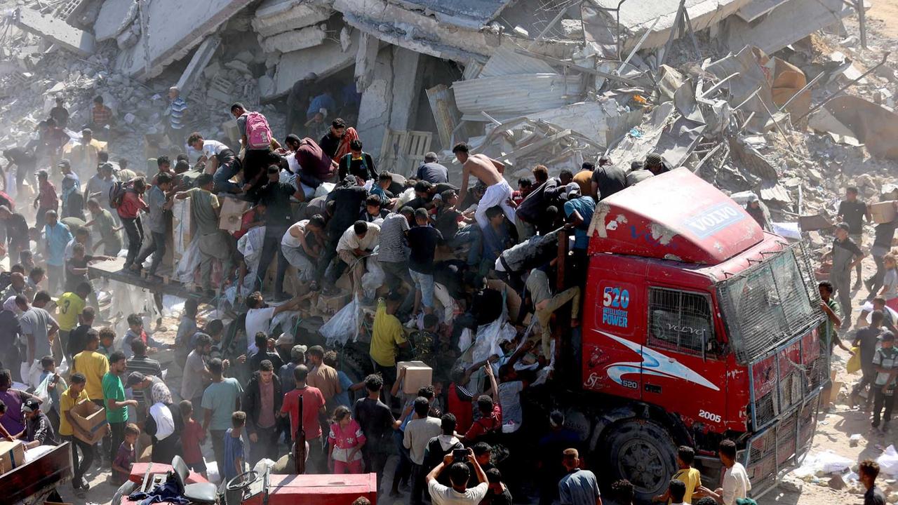 FOTO: Di Tengah Gencatan Senjata, Warga Gaza Berebut Bantuan Bahan Makanan untuk Bertahan Hidup