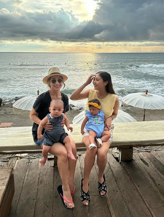 Rona bahagia terlihat jelas di wajah keduanya, memangku bayi-bayi kecil mereka di pinggir pantai. [Foto: Instagram/nikitawillyofficial94]
