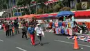 Pedagang kaki lima (PKL) menggelar dagangannya di Jalan Jenderal Sudirman saat Hari Bebas Kendaraan, Jakarta, Minggu (25/8/2019). Para PKL ini menggelar dagangannya terlalu menjorok ke tengah jalan sehingga mengganggu kenyamanan warga yang berolahraga saat CFD. (Liputan6.com/Helmi Fithriansyah)