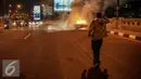 Pemilik mobil terdiam melihat mobilnya terbakar di jalan layang Latuharhari, Jakarta, Kamis (18/9/2015). Diduga kebakaran akibat konsleting listrik yang terjadi dibagian depan kap mobil. (Liputan6.com/Faizal Fanani)