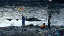 Anak laki-laki menerbangkan layang-layang di tepi sungai menjelang festival Hindu Dashain di Kathmandu (7/10/2020). Festival ini yang paling dinantikan di Nepal, Bhutan, Burma, dan perbukitan India Utara. (AFP/Prakash Mathema)