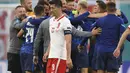 Striker Polandia, Robert Lewandowski (tengah) berjalan saat para pemain Slovakia merayakan kemenangan usai pertandingan grup E Euro 2020 di stadion Saint Petersburg di St. Petersburg, Rusia, Senin (14/6/2021).  Slovakia menang tipis atas Polandia 2-1. (Kirill Kudryavtsev/Pool via AP)