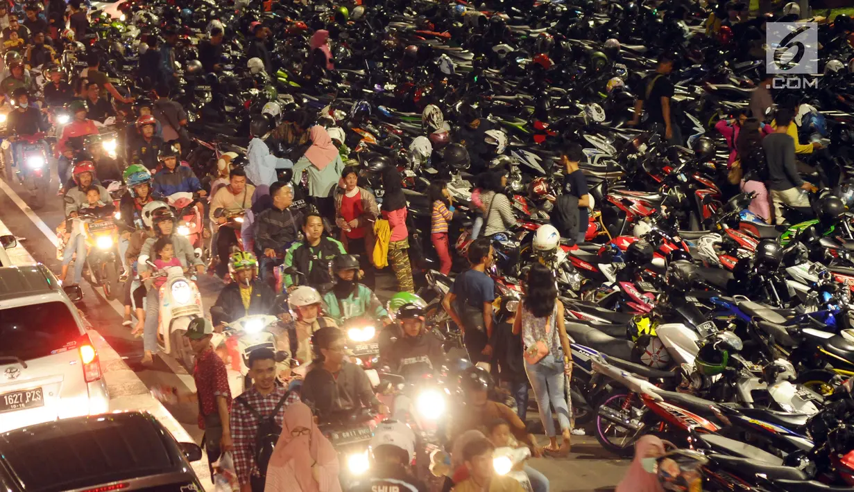 Deretan motor yang terparkir di ruas jalan Medan Merdeka Timur, Jakarta, Minggu (31/12). Akibat banyaknya motor yang parkir, ruas jalan Medan Merdeka Timur menyempit dan terjadi kemacetan panjang. (Liputan6.com/Helmi Fithriansyah)