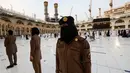 Para polisi wanita Saudi berjaga-jaga saat jemaah mengelilingi Ka'bah pada rangkaian ibadah haji di Masjidil Haram, Makkah, Selasa (20/7/2021). Kini, para personel perempuan bergabung dengan rekan-rekan pria mereka dalam menjaga kota suci selama musim haji. (Fayez Nureldine / AFP)