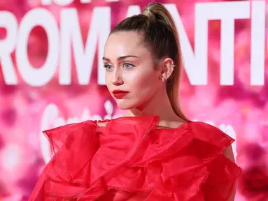 Penyanyi dan artis Hollywood, Miley Cyrus berpose saat tiba menghadiri pemutaran perdana film "Isn't It Romantic" di Los Angeles (11/2). Miley Cyrus tampil memesona dengan gaun berwarna merah Maison Valentino. (AFP Photo/Jean-Baptiste Lacroix)