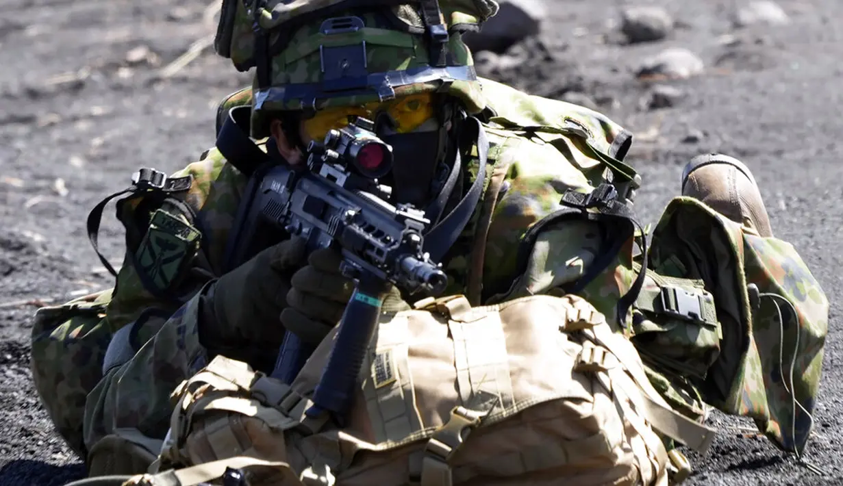 Salah satu anggota Pasukan Bela Diri Darat Jepang (JGSDF) mengambil posisi saat latihan operasi gabungan helikopter militer antara JGSDF dan Marinir AS di Higashi Fuji, Gotemba, Jepang, Selasa (15/3/2022). (AP Photo/Eugene Hoshiko)