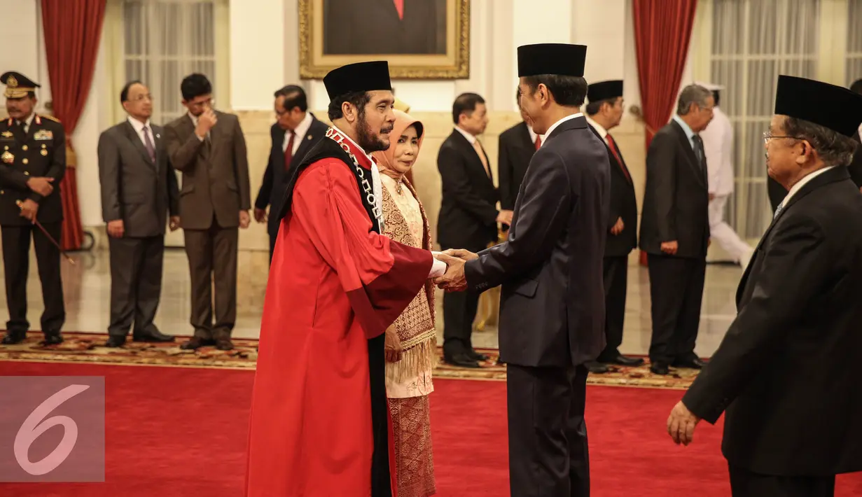 Presiden Joko Widodo memberi selamat  usai Wakil Ketua Mahkamah Konstitusi Anwar Usman mengucapan sumpah sebagai Hakim Konstitusi di Istana Negara, Jakarta, Kamis (6/4). (Liputan6.com/Faizal Fanani)