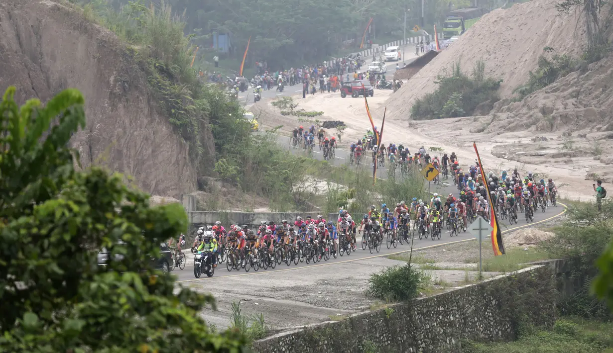Aksi para pebalap sepeda selepas start dari Kantor Bupati Padang Pariaman dalam Etape 2 Tour de Singkarak 2015, Minggu (4/10/2015). (Bola.com/Arief Bagus)