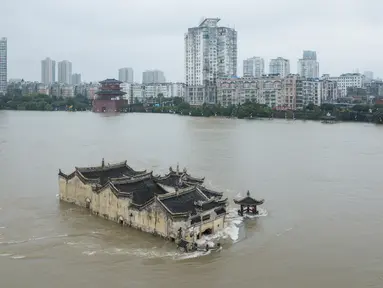 Foto pada 19 Juli 2020 menunjukkan kuil Guanyinge berumur 700 tahun yang dibangun di atas batu, terendam banjir akibat meluapnya sungai Yangtze di Wuhan, provinsi Hubei. Hujan lebat sejak bulan Juni telah menyebabkan sedikitnya 141 orang tewas dan memaksa hampir 15 juta orang dievakuasi. (STR/AFP)