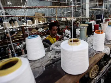 Pekerja memintal benang di Kebayoran, Jakarta, Selasa (5/7/2022). Pabrik benang yang berdiri sejak tahun 1970-an tersebut dapat memproduksi 100 kilogram benang dalam sehari dan dipasarkan ke berbagai daerah di Indonesia. (Liputan6.com/Johan Tallo)