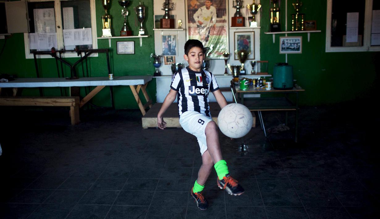 Seorang bocah mengenakan baju Juventus dengan nama Arturo Vidal di pinggiran kota Santiago. (Pablo Sanhueza)