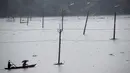 Penduduk desa mendayung perahu-perahu desa melalui genangan air di distrik Morigaon di Assam, India (26/6/2020). Banjir  disebabkan meluapnya Sungai Brahmaputra akibat hujan yang terus turun. (AP Photo/Anupam Nath)