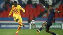 Penyerang Barcelona, Ousmane Dembele menembak bola dari kawalan bek PSG, Presnel Kimpembe pada pertandingan pertandingan leg kedua babak 16 besar Liga Champions di stadion Parc des Princes, Paris (11/3/2021). Barcelona bermain imbang atas PSG 1-1. (AP Photo/Christophe Ena)