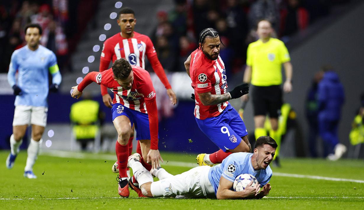 Pemain Lazio, Nicolo Casale, terjatuh saat berebut bola dengan pemain Atletico Madrid pada laga grup E Liga Champions di Stadion Metropolitano, Madrid, Kamis (14/12/2023). Kemenangan ini membuat Atletico Madrid menempati posisi puncak klasemen grup dengan 14 poin, sedangkan Lazio di posisi kedua dengan sepuluh poin.(AP Photo/Pablo Garcia)