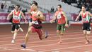 Purnomo Sapto Yogo pelari Indonesia meraih medali emas di nomor 100 meter putra klasifikasi T37 pada Asian Para Games 2018, di Stadion Utama Gelora Bung Karno Jakarta, Selasa (9/10/2018).  (Bola.com/Peksi Cahyo)