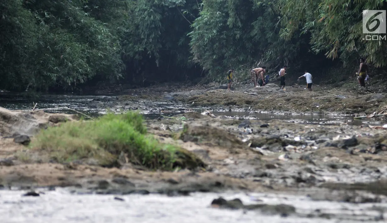 Anak-anak usai berenang di Sungai Ciliwung, Depok, Jawa Barat, Kamis (4/7/2019). Menurunnya debit air Sungai Ciliwung akibat musim kemarau dimanfaatkan warga setempat sebagai tempat wisata gratis untuk mengajak anak berenang. (merdeka.com/Iqbal Nugroho)