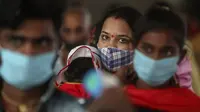 Penumpang yang mengenakan masker menunggu pemeriksaan tes COVID-19 di stasiun kereta jarak jauh di Mumbai, Maharashtra, Minggu (21/3/2021). India sedang menghadapi gelombang baru infeksi Covid-19 dan mencatat rekor lonjakan harian tertinggi dalam hampir empat bulan terakhir. (AP Photo/Rafiq Maqbool)