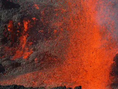 Semburan lava pijar dari Gunung Piton de la Fournaise, La Reunion, Prancis, Rabi (1/2). Gunung tersebut kembali meletus pada Selasa (31/1) malam waktu setempat dan terus menyemburkan lava pijar. (AFP Photo/Richard Bouhet)