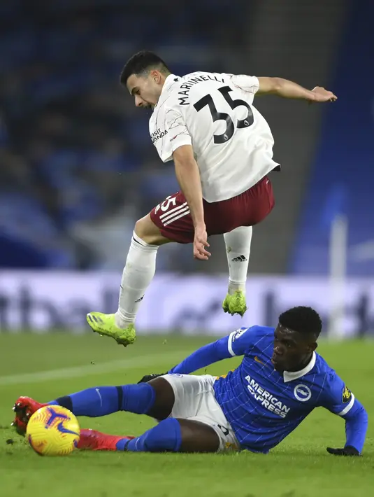 Gelandang Brighton & Hove Albion,  Yves Bissouma berusaha merebut bola penyerang Arsenal, Gabriel Martinelli pada pertandingan lanjutan liga Inggris di stadion Falmer di Brighton, Inggris, Rabu (30/12/2020). Meriam London menang tipis 1-0 atas Brighton. (Mike Hewitt/Pool via AP)