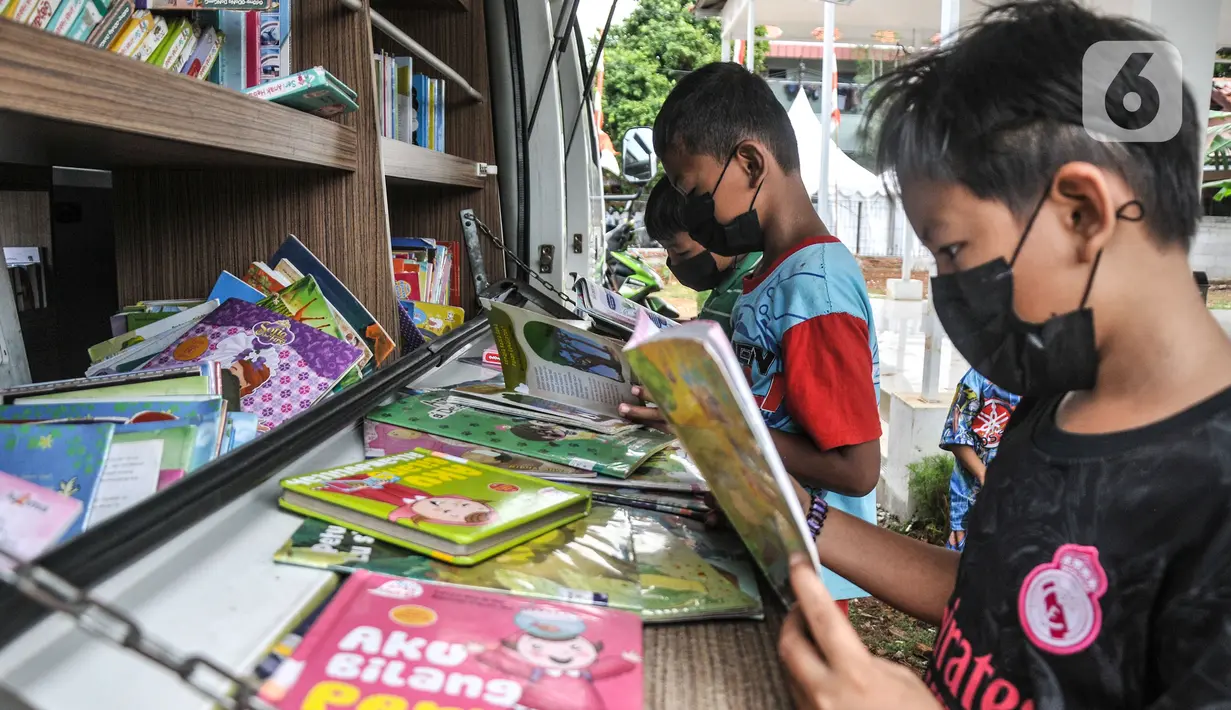 Anak-anak membaca buku di Perpustakaan Keliling kawasan Jatinegara, Jakarta, Rabu (29/9/2021). Mobil Perpustakaan Keliling yang difasilitasi Dinas Perpustakaan dan Kearsipan DKI itu merupakan sarana dan upaya pemerintah dalam meningkatkan minat baca anak sejak dini. (merdeka.com/Iqbal S Nugroho)