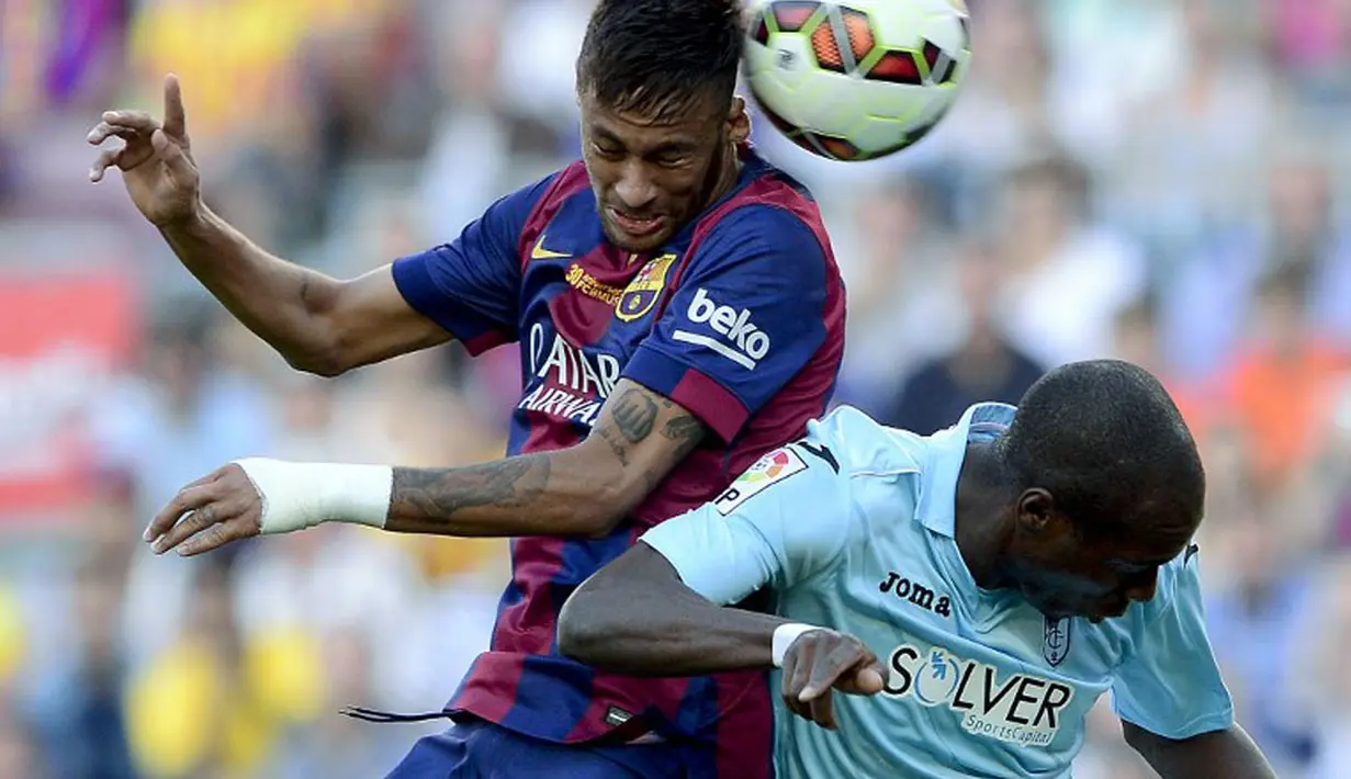 Penyerang Barcelona, Neymar da Silva (kiri), berduel dengan Allan Romeo Nyom saat berlaga di lanjutan La Liga 2014 di Stadion Camp Nou, (27/9/2014). Barcelona unggul enam gol tanpa balas atas Granada. (AFP PHOTO/Josep Lago)