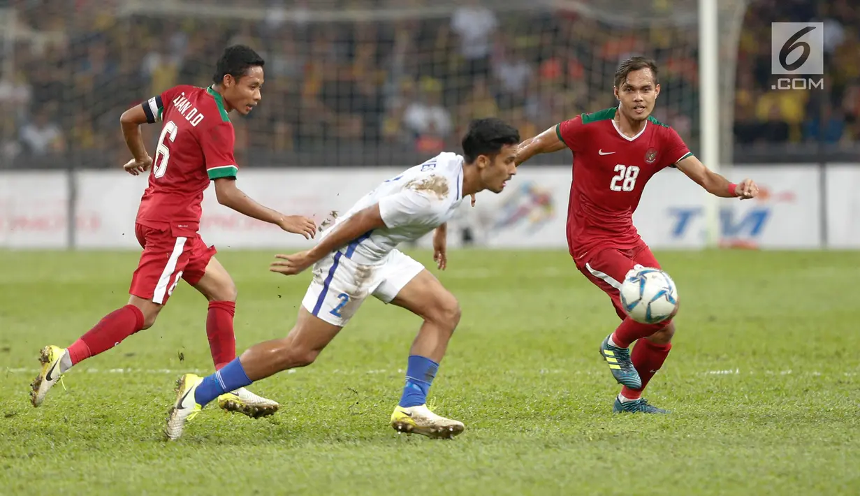 Pemain Timnas U-22,  M Rezaldi Hehanusa dan Evan Dimas berusaha merebut bola pada pêrtandíngan Sepak Bola Indonesia melawan Malaysia di Stadion Shah Alam, Selangor, Sabtu (26/08). Indonesia kalah 0-1 dari tuan rumah Malaysia. (Liputan6.com/Faizal Fanani)