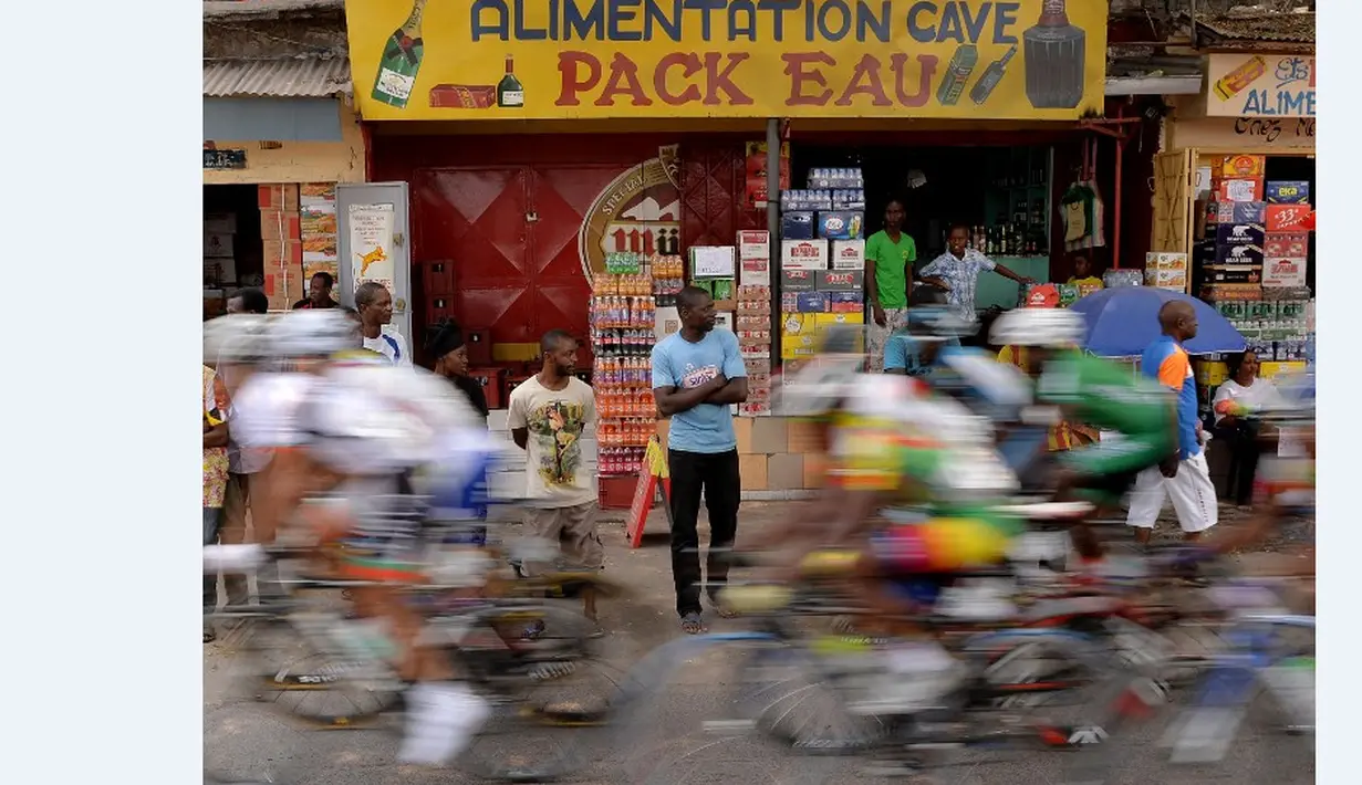 Warga melihat barisan pebalap sepeda yang berlomba dalam Africa Games di Brazzaville, Kongo. (13/9/2015). (AFP Photo/Monirul Bhuiyan)