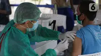 Vaksinator menyuntikkan vaksin COVID-19 untuk warga di Taman Dadap Merah, Kebagusan, Jakarta, Sabtu (10/7/2021).  Pelaksanaan vaksinasi melalui mobil vaksin keliling juga diperuntukkan untuk anak usia 12 tahun ke atas. (Liputan6.com/Helmi Fithriansyah)