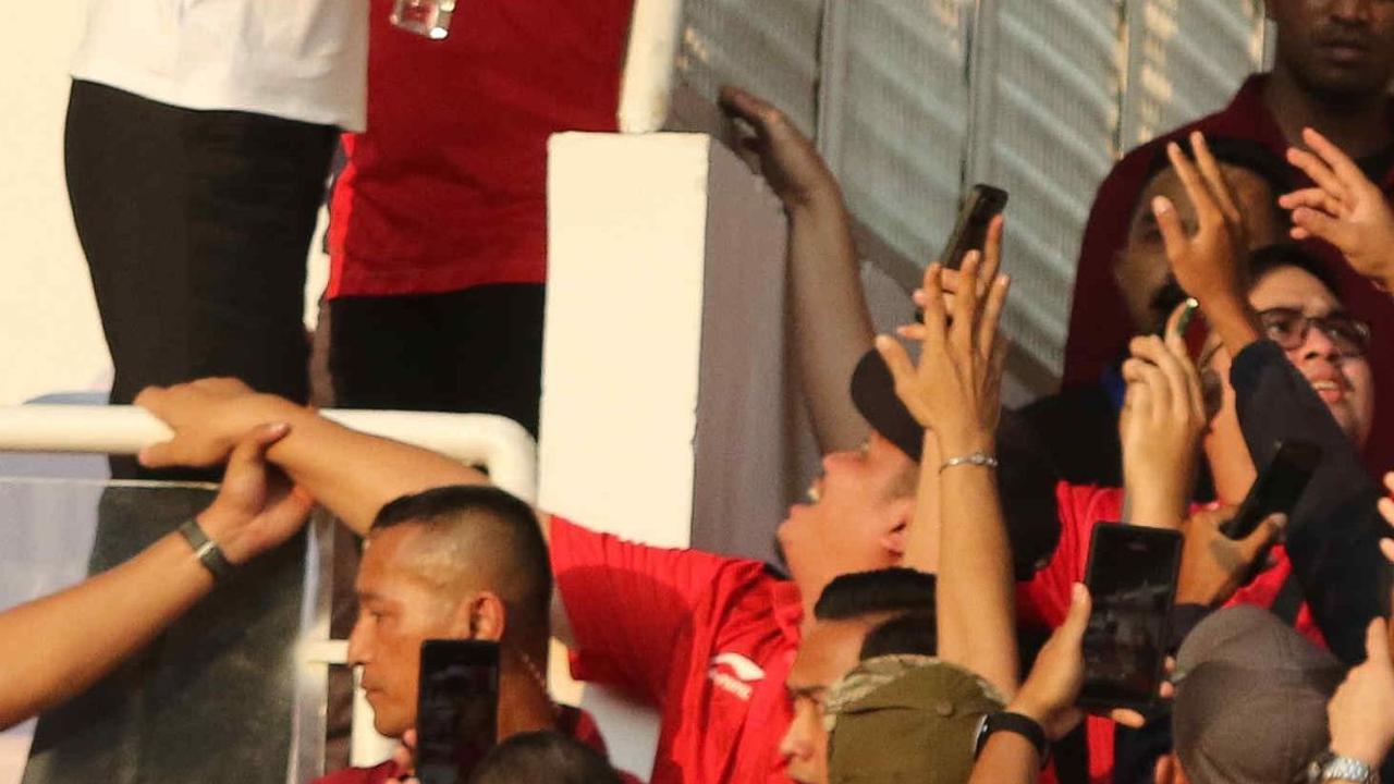 Presiden Jokowi membagikan minum kepada para suporter Timnas Indonesia.&nbsp;Foto: Liputan6.com/Herman Zakharia