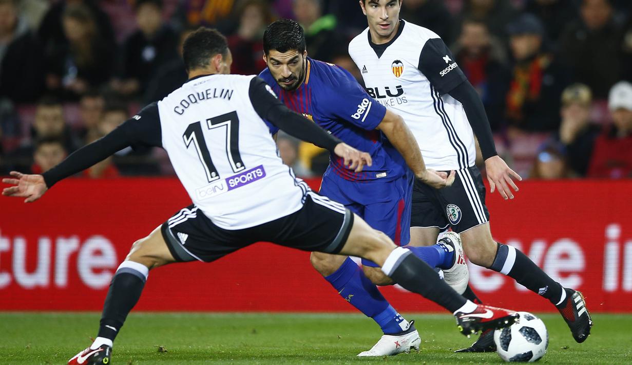 Striker Barcelona, Luis suarez, berusaha melewati pemain Valencia pada laga leg pertama semifinal Copa Del Rey di Stadion Camp Nou, Jumat (2/2/2018). Barcelona menang 1-0 atas Valencia. (AP/Manu Fernandez)