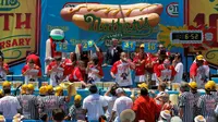 Sejumlah peserta berlomba memakan Hot Dog di Nathan's Famous 4 Fourth of July International Hot Dog-Eating Contest, New York , AS, (4/7).  Salah satu lomba makan Hot Dog terbesar diikuti peserta pria dan wanita. ( REUTERS / Andrew Kelly)