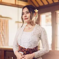 Prilly Latuconsina tampil memukau dalam balutan kebaya Bali lengan panjang berwarna putih. Kebaya tersebut dipadukan dengan kain jarik berwarna ungu. Tak lupa disempurnakan dengan sabuk khas Bali. (Instagram/prillylatuconsina).